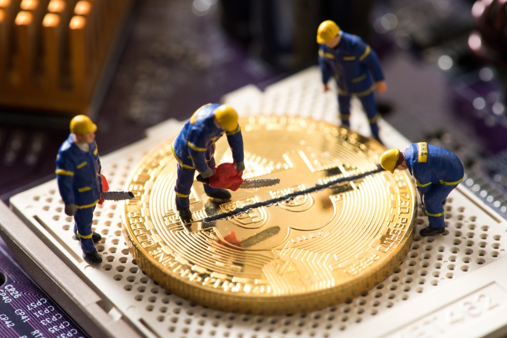 btc-halving-1 miniature worker cutting bitcoin , halving concept