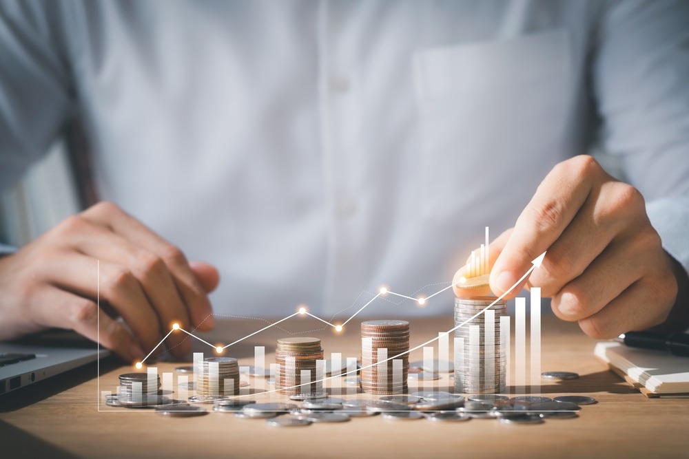 Business man putting coins Business growth and investment chart, strategic planning to increase profits from doing business, long-term investment planning.