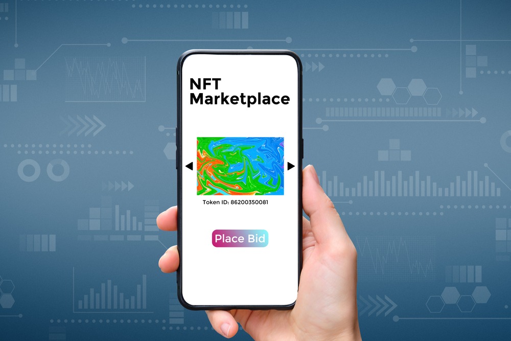 nft-marketlace-1 A hand holds a smartphone with an type of cryptographic NFT marketplace art with place bid