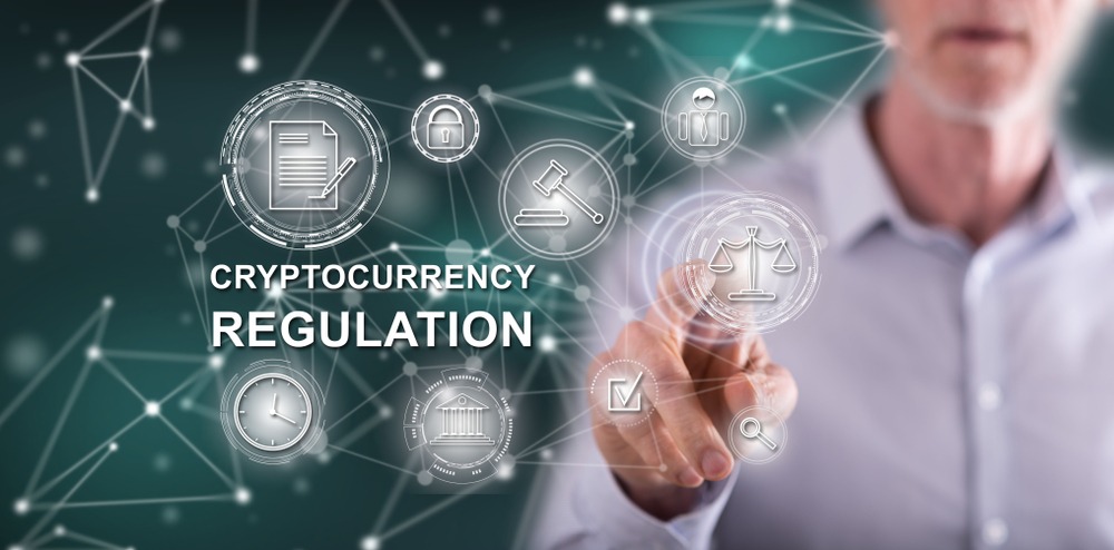 Man touching a cryptocurrency regulation concept on a touch screen with his finger