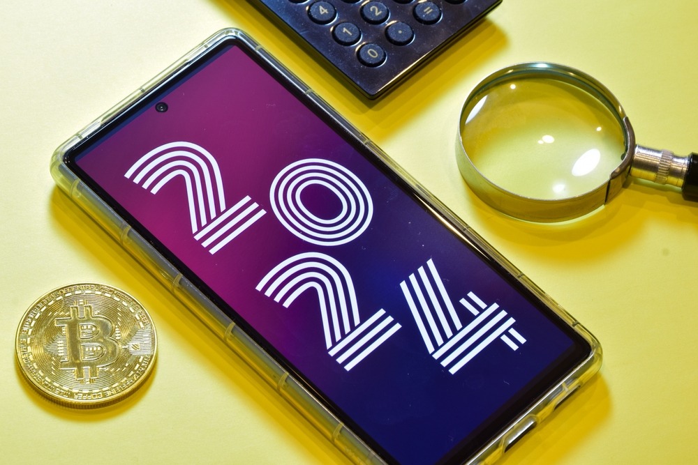 Crypto currency trading retirement trends in the year 2024 concept on desk with calculator and Bitcoin token.