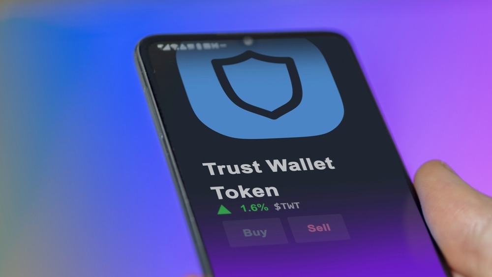 An investor analyzing the price of Trust Wallet Token, the token coin $TWT on a crypto exchange sreen.